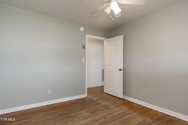 unfurnished room featuring visible vents, ceiling fan, wood finished floors, and baseboards