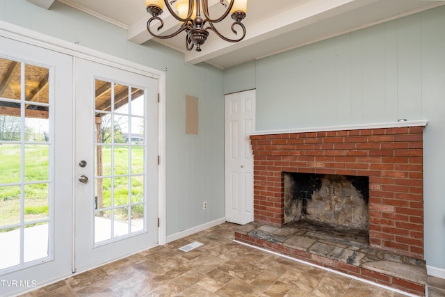 doorway with a chandelier, plenty of natural light, visible vents, and baseboards