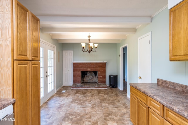 interior space with an inviting chandelier, beamed ceiling, baseboards, and stone finish flooring