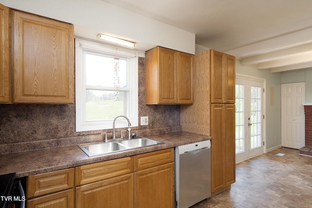 kitchen featuring beamed ceiling, stainless steel dishwasher, a sink, dark countertops, and backsplash
