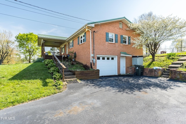 view of property exterior with a yard, a garage, stairway, brick siding, and driveway