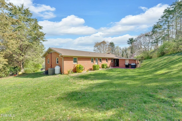 102 Delta Cir, Greeneville, TN 37743 - back of house with brick siding, central air condition unit, and a lawn