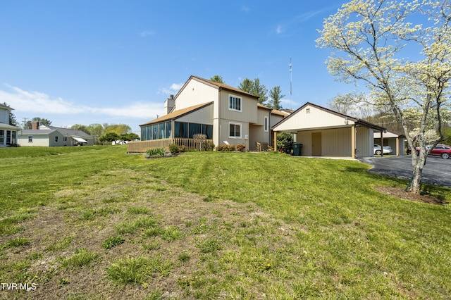 1023 Pebble Dr, Bristol, VA 24201 - exterior space featuring a sunroom, a carport, a yard, and aphalt driveway