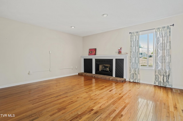 1023 Pebble Dr, Bristol, VA 24201 - unfurnished living room with baseboards, recessed lighting, visible vents, a brick fireplace, and wood-type flooring