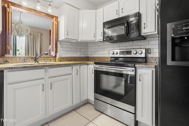 1023 Pebble Dr, Bristol, VA 24201 - kitchen with light tile patterned floors, white cabinetry, black appliances, a chandelier, and a sink