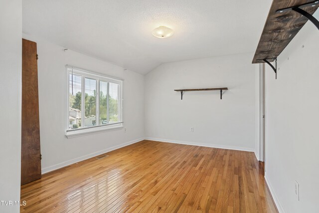 1023 Pebble Dr, Bristol, VA 24201 - spare room featuring visible vents, baseboards, light wood-type flooring, and vaulted ceiling