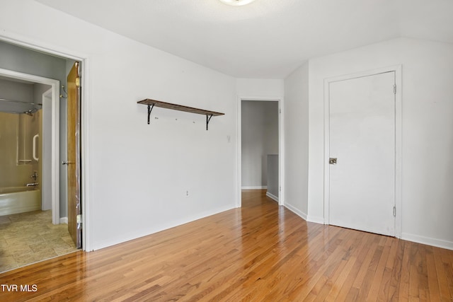 1023 Pebble Dr, Bristol, VA 24201 - unfurnished bedroom with ensuite bath, light wood-style flooring, and baseboards