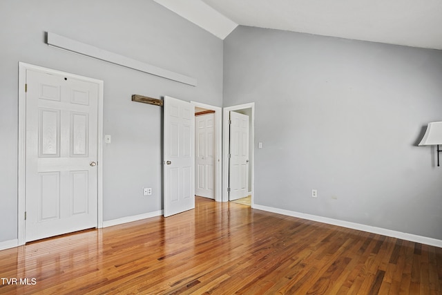 1023 Pebble Dr, Bristol, VA 24201 - unfurnished bedroom featuring high vaulted ceiling, baseboards, and wood finished floors
