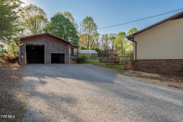 view of side of property with an outbuilding and a detached garage