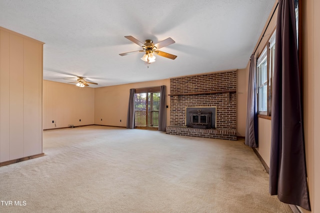 unfurnished living room with baseboards, a ceiling fan, and light carpet
