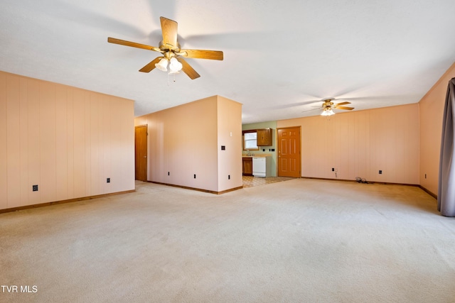 unfurnished living room with light colored carpet, ceiling fan, and baseboards