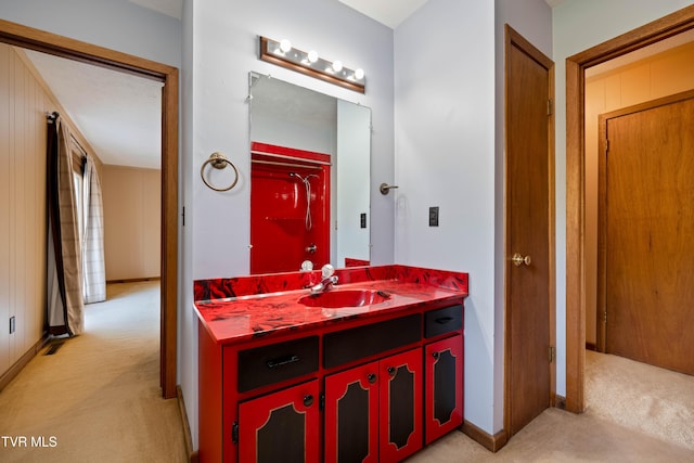 bathroom with a closet, vanity, and baseboards