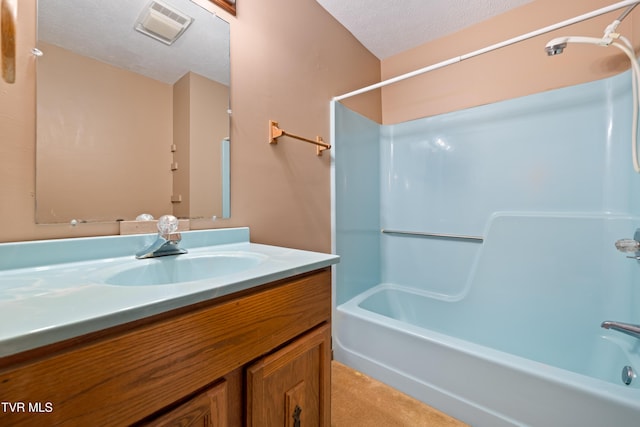 bathroom featuring bathing tub / shower combination, a textured ceiling, vanity, and visible vents