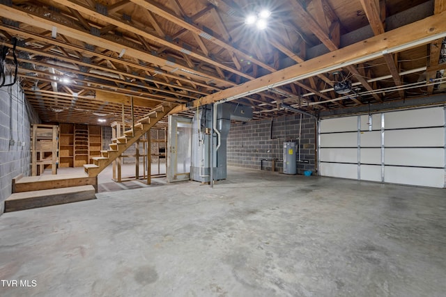 garage with water heater and concrete block wall
