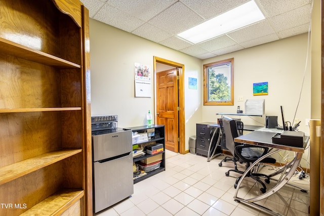 office area featuring light tile patterned floors and a paneled ceiling