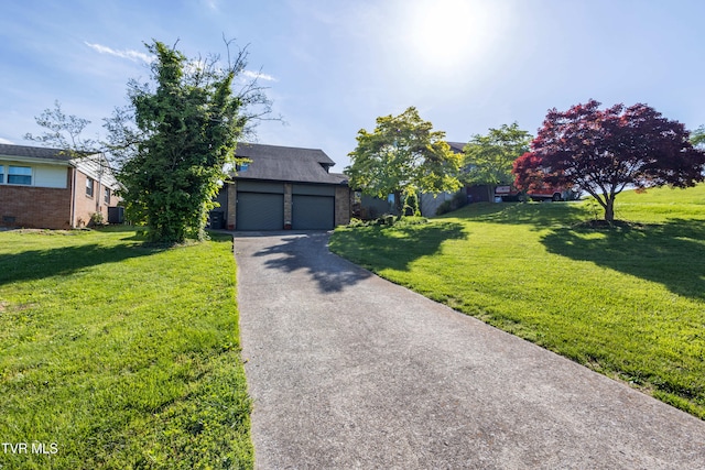 obstructed view of property featuring brick siding, a front lawn, and asphalt driveway