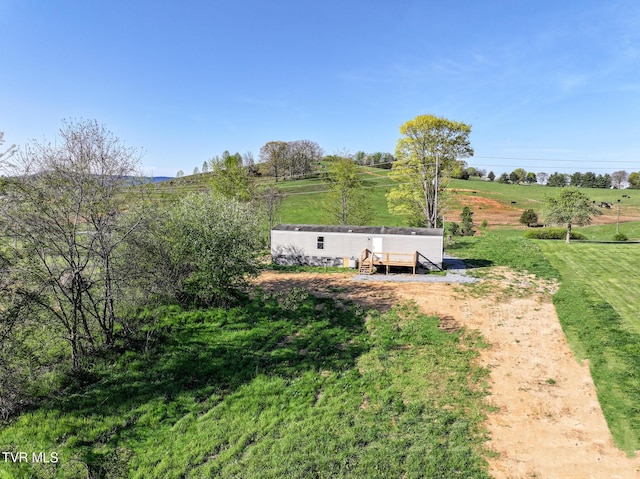 810 Sugar Bowl Rd, Chuckey, TN 37641 - entry to storm shelter featuring a lawn and a rural view