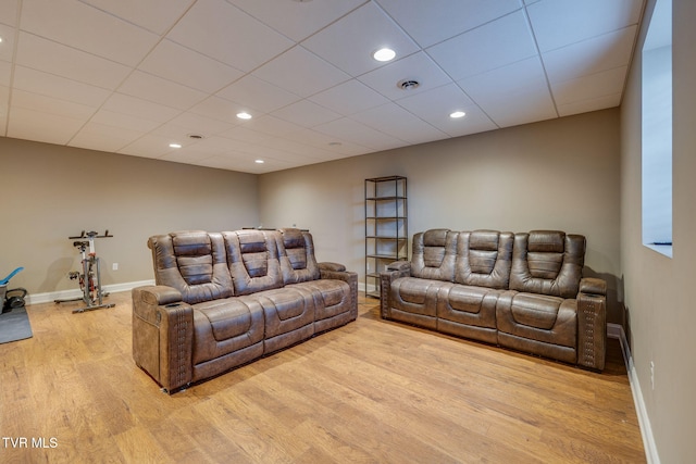 living area with wood finished floors, recessed lighting, and baseboards