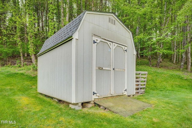 view of shed with a forest view