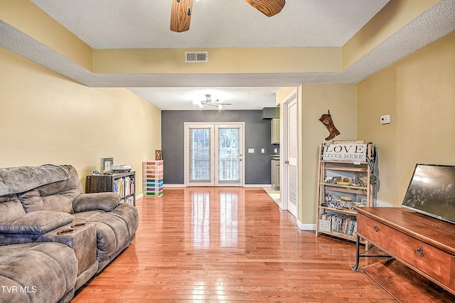 305 Waterford Ct Unit 305, Johnson City, TN 37615 - living room featuring visible vents, baseboards, a ceiling fan, a textured ceiling, and light wood finished floors