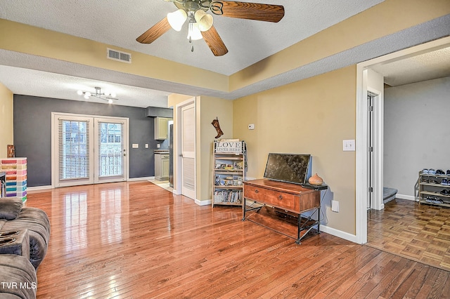 305 Waterford Ct Unit 305, Johnson City, TN 37615 - living area featuring light wood-type flooring, baseboards, a ceiling fan, and a textured ceiling