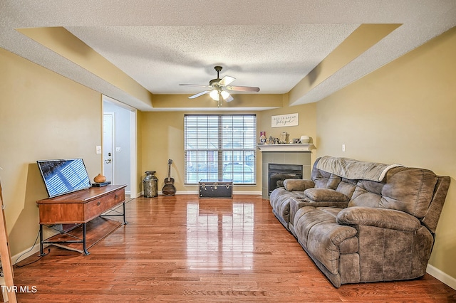 305 Waterford Ct Unit 305, Johnson City, TN 37615 - living room featuring a fireplace, ceiling fan, a textured ceiling, and wood finished floors