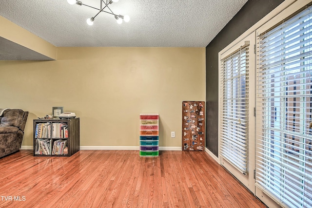 305 Waterford Ct Unit 305, Johnson City, TN 37615 - interior space featuring a textured ceiling, wood finished floors, an inviting chandelier, and baseboards