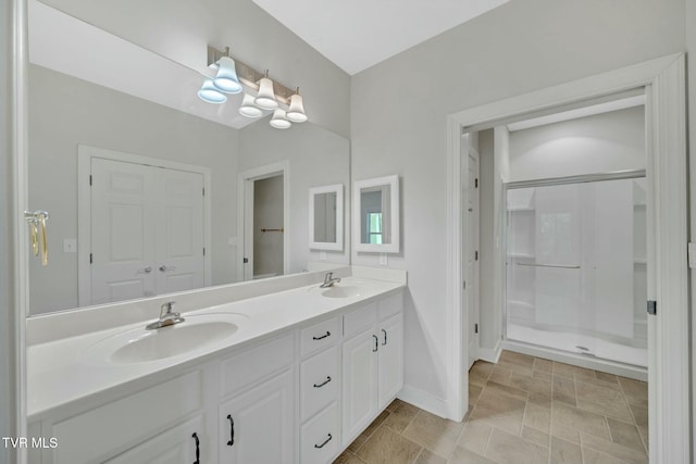 211 University Pkwy Unit 16, Johnson City, TN 37604 - full bathroom featuring double vanity, a sink, baseboards, and walk in shower