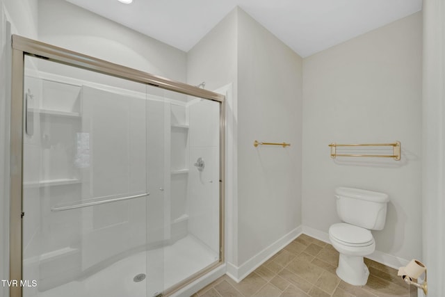 211 University Pkwy Unit 16, Johnson City, TN 37604 - bathroom featuring toilet, a stall shower, and baseboards