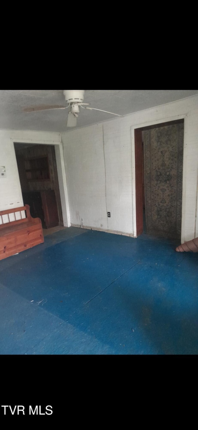 unfurnished living room featuring ceiling fan