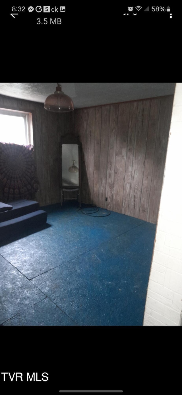 empty room featuring wooden walls