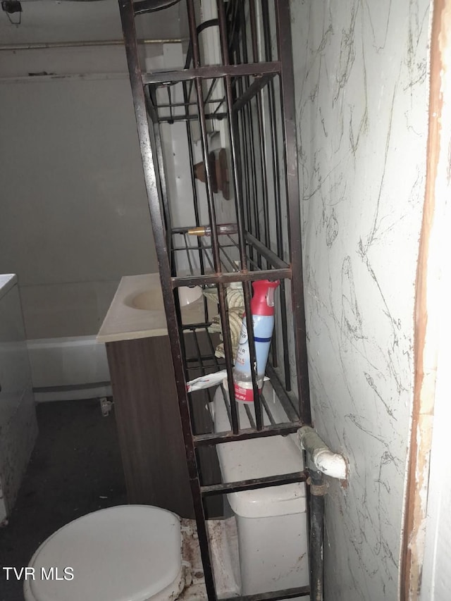 bathroom featuring toilet and vanity