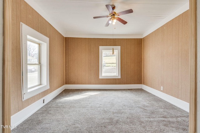 carpeted empty room featuring ceiling fan