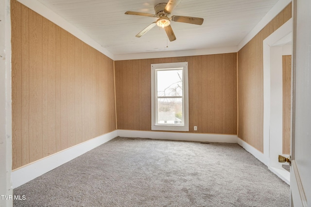 spare room featuring ceiling fan and carpet flooring