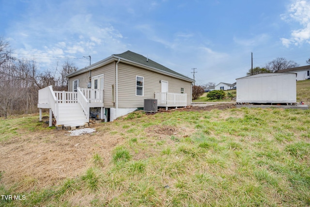 view of home's exterior featuring a deck, an outbuilding, a storage shed, and central AC unit