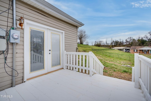view of patio featuring a wooden deck and fence