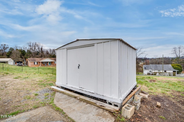 view of shed featuring fence
