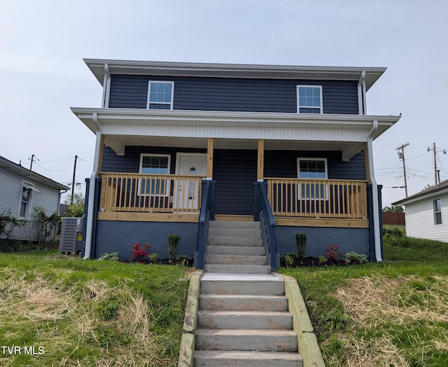 view of front of house featuring a porch and cooling unit