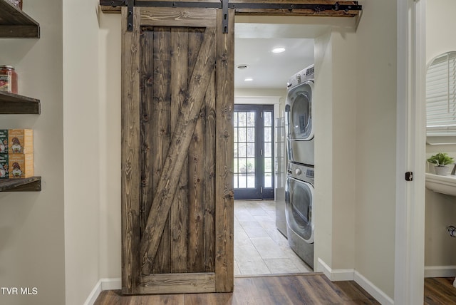 368 New Hope Rd, Jonesborough, TN 37659 - laundry area with stacked washing machine and dryer, recessed lighting, wood finished floors, and a barn door