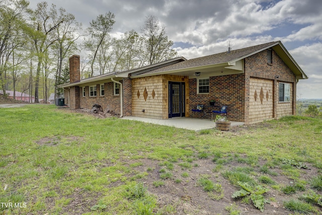 368 New Hope Rd, Jonesborough, TN 37659 - rear view of house featuring a chimney, brick siding, a yard, and a patio area