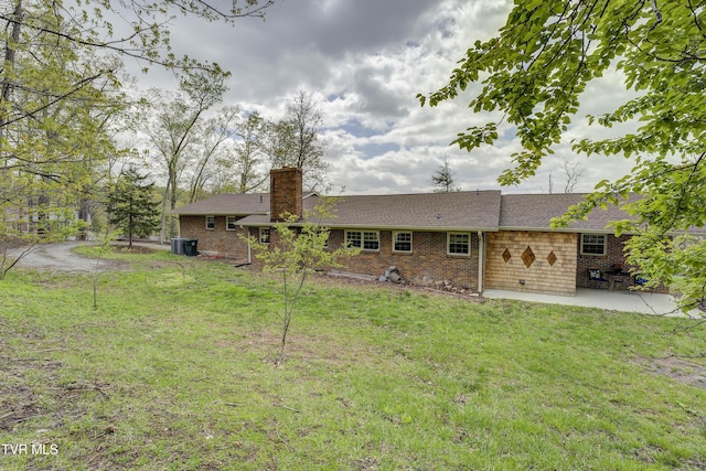 368 New Hope Rd, Jonesborough, TN 37659 - rear view of house with a chimney, a patio, a yard, brick siding, and a shingled roof