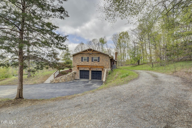 368 New Hope Rd, Jonesborough, TN 37659 - view of property exterior featuring asphalt driveway, an attached garage, a chimney, and brick siding