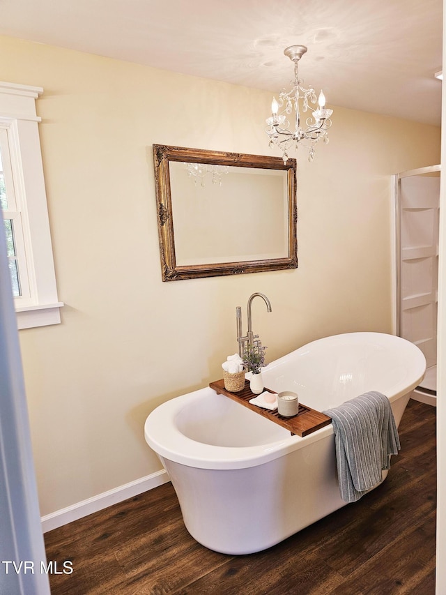 368 New Hope Rd, Jonesborough, TN 37659 - bathroom with wood finished floors, a freestanding tub, and a chandelier