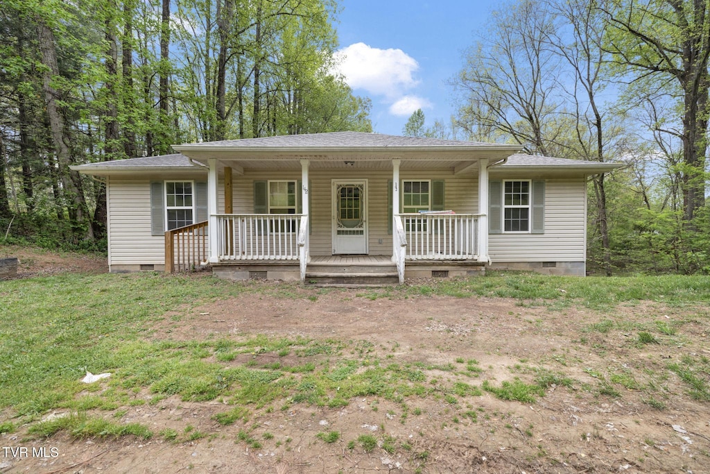 rear view of property featuring a porch, roof with shingles, and crawl space