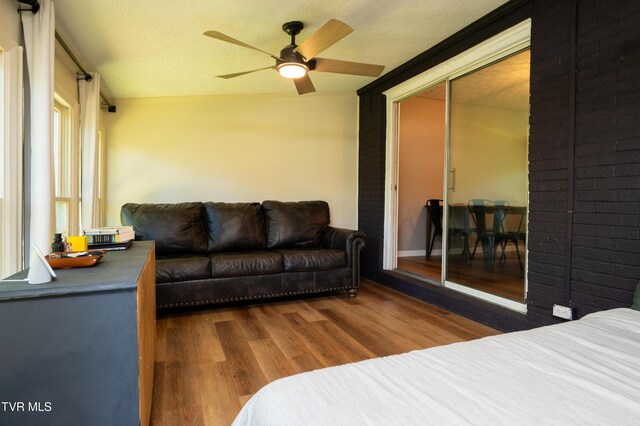 bedroom featuring a closet, wood finished floors, a textured ceiling, and ceiling fan