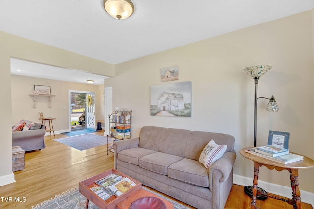 living room with baseboards and light wood finished floors