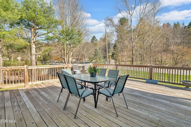 wooden terrace with outdoor dining area