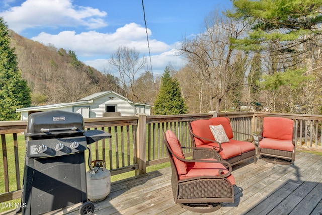 wooden deck featuring grilling area and a mountain view