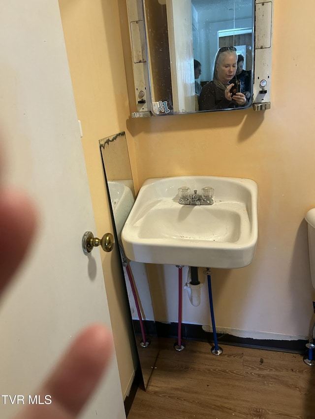 604 E Church Hill St, Greeneville, TN 37745 - half bathroom featuring baseboards, wood finished floors, and toilet