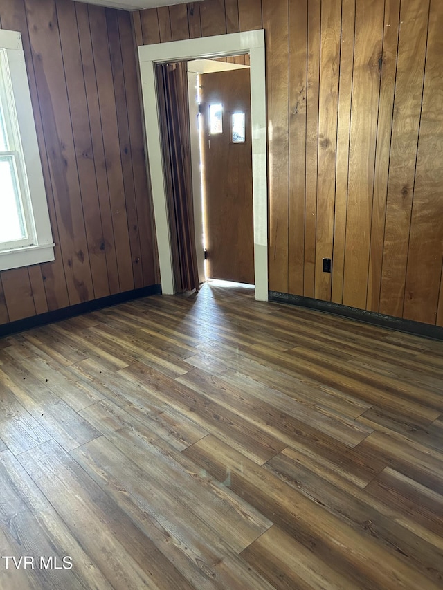 604 E Church Hill St, Greeneville, TN 37745 - empty room with dark wood-style flooring and wood walls